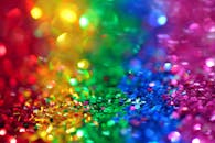 Colorful bokeh effect with vibrant rainbow glitter, perfect for festive backgrounds.