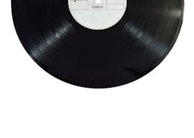 A classic black vinyl record isolated on a white background.