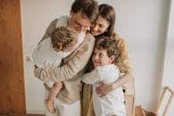 A heartwarming scene of a family hugging indoors, showcasing love and togetherness.