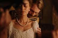 Intimate moment with a couple in period costume, exuding romance and elegance.