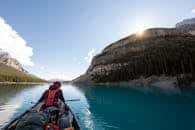 A serene kayaking journey on a crystal lake in Banff National Park, Canada.