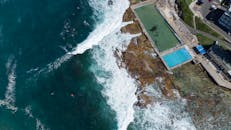 Stunning aerial view of Dee Why rock pools and crashing ocean waves, NSW, Australia.