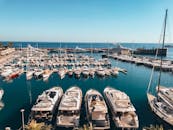 A stunning view of luxury yachts in the vibrant Monaco harbor under a clear sky.