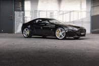 Black Aston Martin V8 Vantage parked outdoors in Sydney, showcasing luxury automotive design.