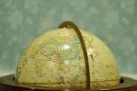 Close-up of a vintage globe in soft focus, showcasing Asia and surrounding regions.