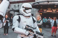 Stormtrooper character in costume at a busy sci-fi themed park event.