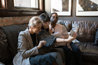 A group of diverse friends enjoying a selfie together on a cozy couch in a stylish interior.