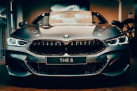 Front view of a shiny luxury BMW car with distinctive headlights and emblem.