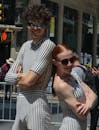 Stylish couple wearing matching striped outfits at a street event in NYC.