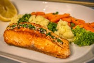 Delicious grilled salmon served with vibrant mixed vegetables, perfect for a healthy meal.