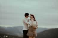 A loving couple embracing amidst the scenic autumn mountains of Beliș, Romania.