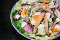 Delicious gourmet salad topped with eggs and tempura vegetables, perfect for a fancy dining experience.