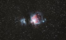 A breathtaking photograph of the Orion Nebula amidst a starry night sky, capturing celestial beauty.